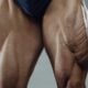 Close-up of muscular quadriceps and calves with visible veins, the leg muscles that pump blood back toward the heart